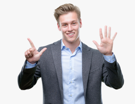 Young handsome blond business man showing and pointing up with fingers number seven while smiling confident and happy.の写真素材