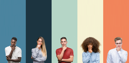 Group of people over vintage colors background looking confident at the camera with smile with crossed arms and hand raised on chin. Thinking positive.の写真素材