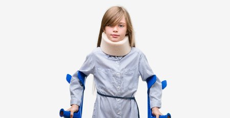 Young blonde child injured wearing neck collar and crutches with a happy face standing and smiling...