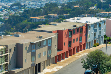multicolored houses in modern neighborhood in san francisco california midday in sun with cars late afternoon in suburbs and city streetsの写真素材