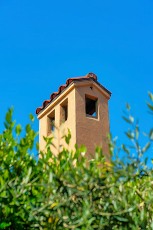 Modern home exterior or facade with victorian accents and decorations and tall chimney with blue and white gradient sky in the front yard. In the city or neighborhood in suburban area.の写真素材