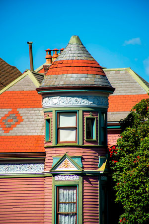Row of modern house facades beige and green in late afternoon shade and blue and white gradient sky background. In the downtown neighborhood in historic districts of San Francisco California.の写真素材