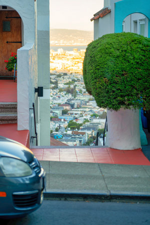 Gradient orange moutain sunset hills in the distance with shadow neighborhood in the downtown districts of San Francisco. Late in the day in california with houses and homes in city.の写真素材
