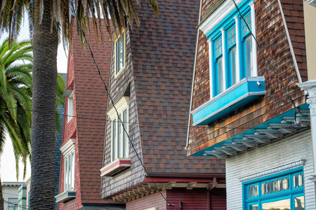 Decorative chimneys in row in neighborhood with wooden slats or panels with metal tops and gradient...