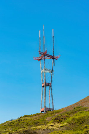 patrial sutro tower with grassy hillside foreground and clear blue sky background with no clouds in sunlight late afternoonの写真素材