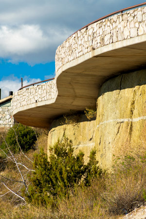 Patio or overlook in a rest stop in a mountain road region in hills and cliffs of arizona nature with stones and cement blocks. Balcony in rural park or recreation area for hikers and travelers.の写真素材