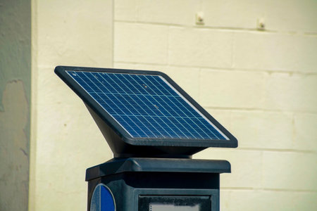 Parking pass kiosk in downtown urban area of city neighborhoods with solar pannel for cultivating green energy. Smart city design for combating climate change in middle class suburban urban area.の写真素材