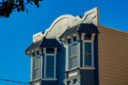 Decorative house or home facade with wooden awnings and blue exterior with beige side wall and front...