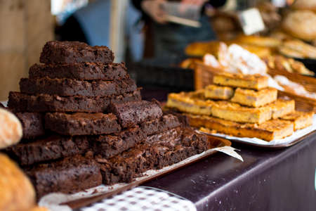 Delicious freshly baked slices and brownies arranged on a counter topの写真素材