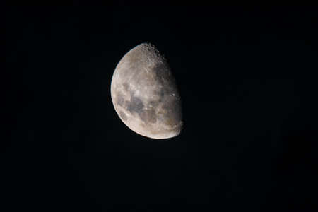 The Moon during it's waxing gibbous phase, showing the subtle colours of the lunar surfaceの写真素材