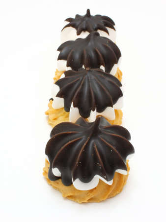 Cookies with a white stuffing covered from above chocolate glaze