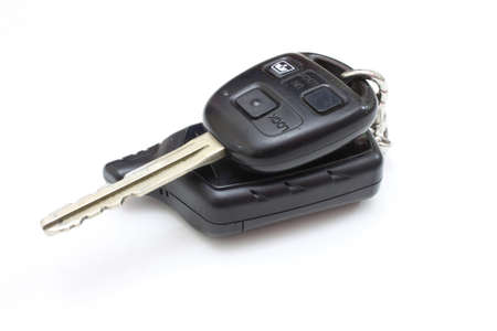 The key from the car with buttons lies is isolated on a white background