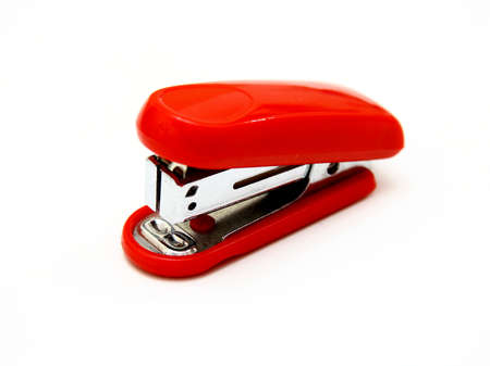 The red stapler lies on a white backgroundの写真素材
