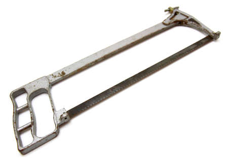 The old hacksaw on metal lies on a white backgroundの写真素材
