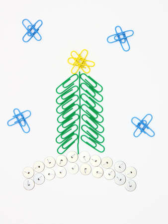 Christmas fur-tree from paper clips for a paper on a white backgroundの写真素材