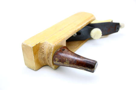 Wooden plane, boards and a shaving on a white background
