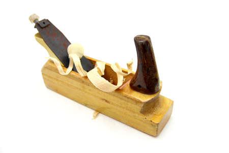 Wooden plane, boards and a shaving on a white background