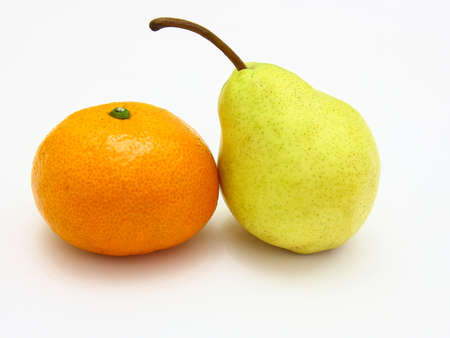 Fruit, tangerine and pear lie on a white backgroundの写真素材