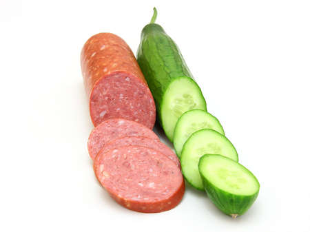 Fresh sausage and cucumber lie nearby on a white backgroundの写真素材