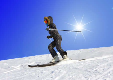 The young girl on skis goes from mountain in a spotty suitの写真素材