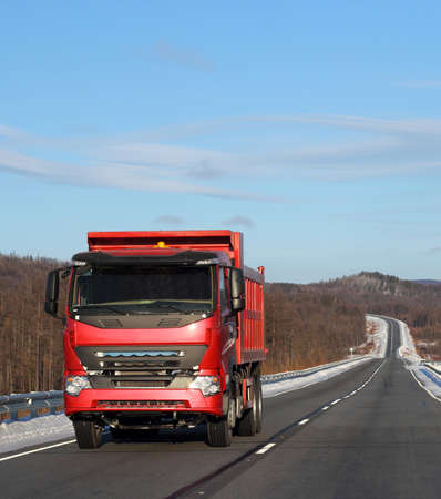 The red truck on a winter road.の写真素材