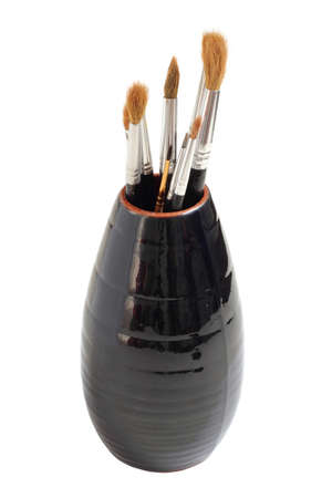 Vase with brushes of the artist on a white backgroundの写真素材