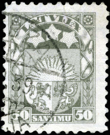 LATVIA - CIRCA 1923: A stamp printed in Latvia shows Latvian Coat of Arms, circa 1923のeditorial素材