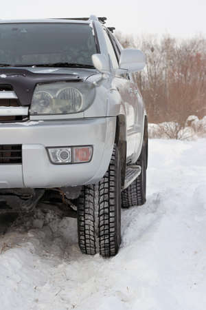 Snowy winter road ahead an unrecognizable car