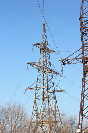 high voltage post against the blue sky