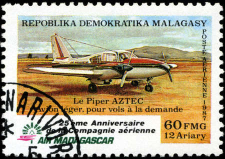REPUBLICA MALAGASY - CIRCA 1987: A stamp printed in Malagasy (Madagascar) shows plane Aztec, circa 1987の写真素材