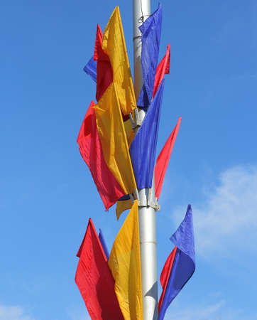 colored flags on a blue sky backgroundの写真素材