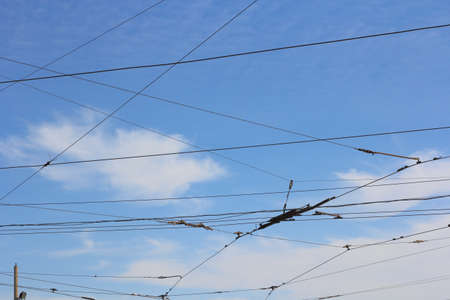 Railroad railway catenary lines against clear blue sky  の写真素材