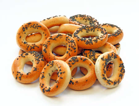 Drying bagels with poppy seeds on a white backgroundの写真素材