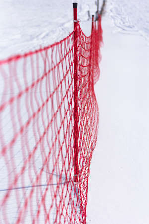 Plastic fence and snow, ski slope limit.の写真素材