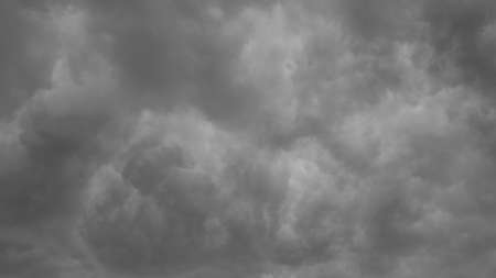 Ominous clouds drift slowly across the sky, threatening rain.