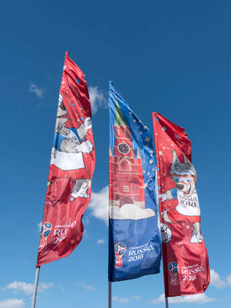 MOSCOW Russia - JUNE 20, 2018: Waving flags with symbols of FIFA World Cup Russia 2018 Zabivaka on a blue sky background on June 20, 2018 in Moscow, Russia.のeditorial素材