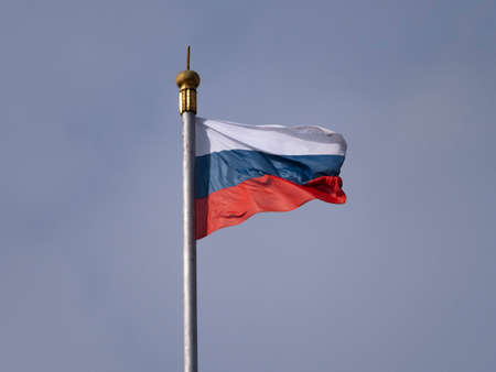 Russian flag fluttering in the wind on a flagpole.の写真素材