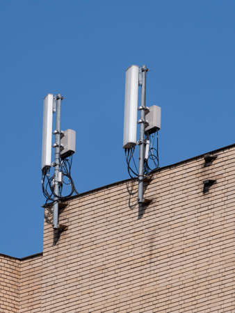Mobile communication antennas on the wall of a building.