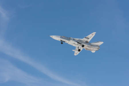 Military jet bomber Su-24 Fencer flying above ground.の写真素材