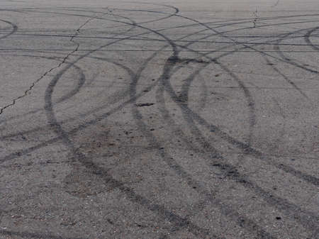 Black trail from rubber tires on the asphalt.