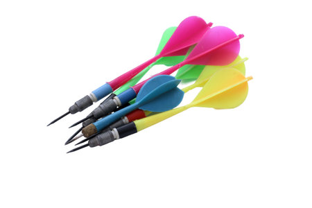 Colorful darts stuck with plastic feathers isolated on white background.