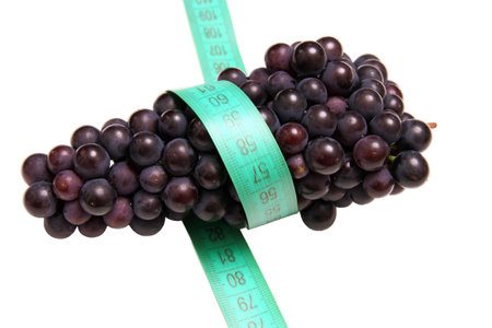Tasty grape and measuring tape isolated on white background.の写真素材