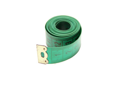 Twisted green measuring tape isolated on white.