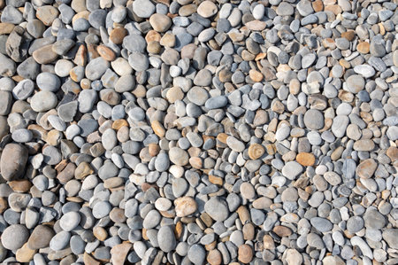 Collection of natural river stones with a rough texture and gray color.の写真素材