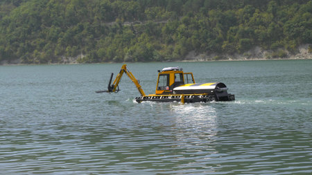 Abrau Durso, Russia 28 August 2024: Municipal aquatic weed harvesting equipment passes along lake Abrau-Durso .のeditorial素材