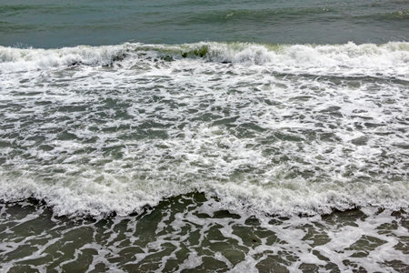 Stormy sea with powerful waves, white foam and strong wind, capturing dramatic marine weather,...