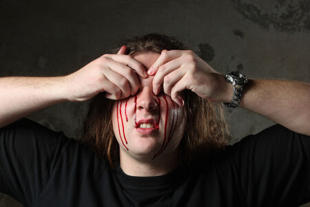 Man taking out his eyes, full of bloodの写真素材