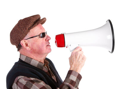 Senior Man Shouting Through Megaphone Over White Backgroundの写真素材