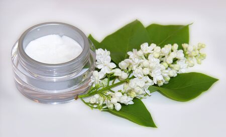 jar natural cream sprig bloom white lilac cosmetic set isolated on grey background. Feminine, beauty and cosmetics conceptの写真素材