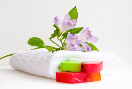 bathroom accessories, luff,  alstroemeria flower, handmade soap and white towelの写真素材